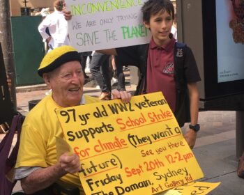 Late Sutherland based environmental activist, Bill Ryan, protests for climate action with young boy